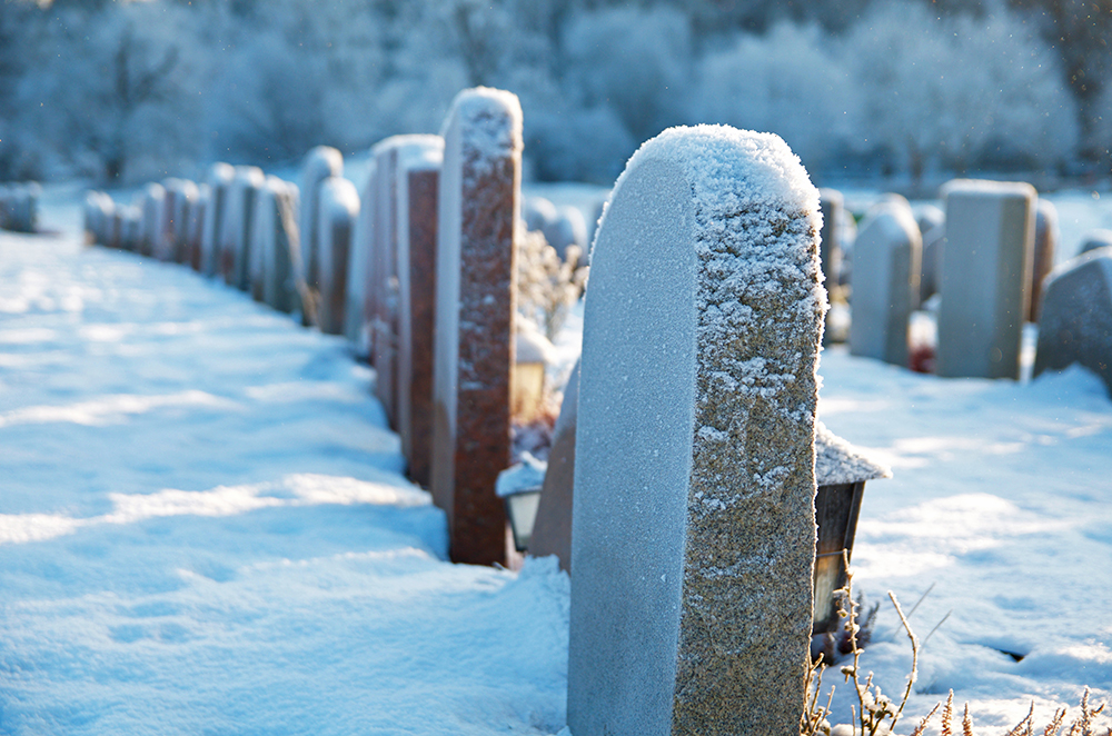 a snowy graveyard with headstones