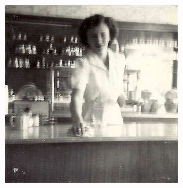 Olive wiping the counter in a restaurant