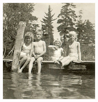 children sitting on a dock