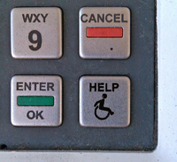 A keypad at a gas pump. Among the number buttons is a button that reads HELP. Beneath the word help is the iconic wheelchair user symbol.