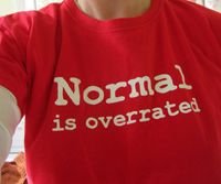 A red t-shirt that says NORMAL IS OVERRATED