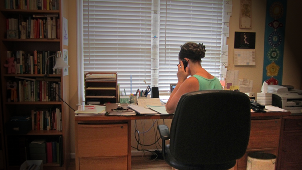 A photo of Margaret in her home office, on a phone interview.