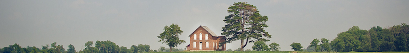 A photo of a farmhouse off in the distance with the text 'Introductin' over top of the image