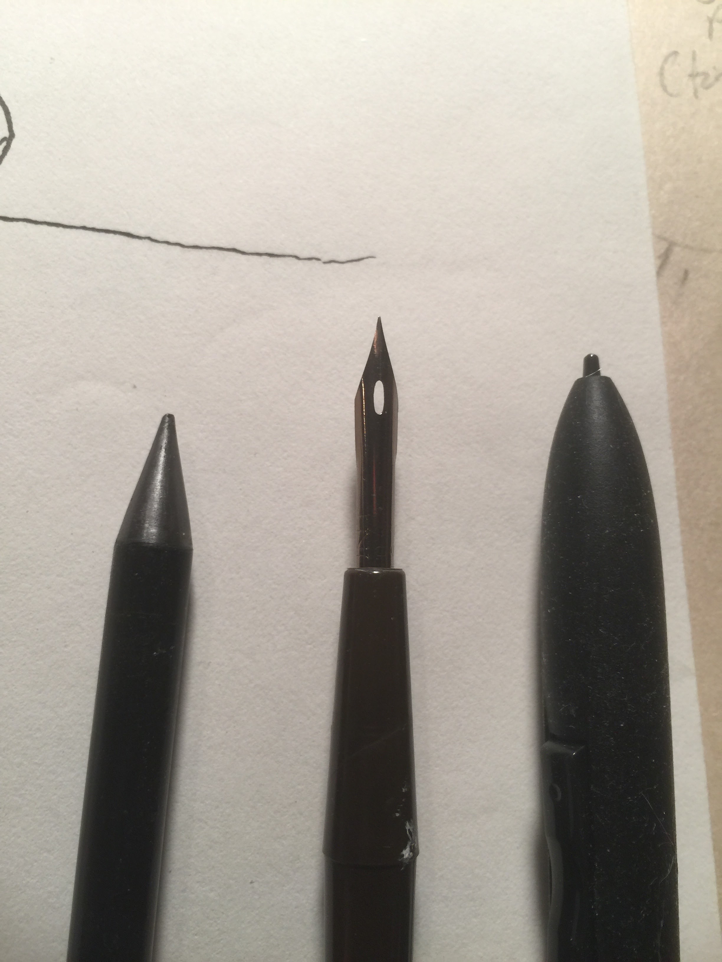 three black styli on a white piece of paper