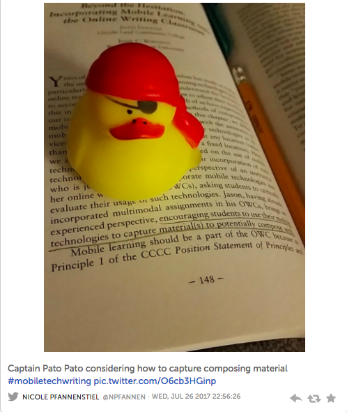 Image of a tweet with a pirate rubber duck sitting on the book being reviewed in this webtext. The image reads: "Captain Pato Pato considering how to capture composing material #mobiletechwriting"