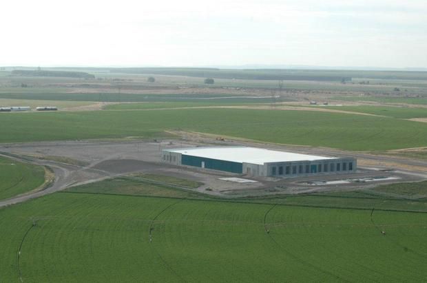 an overhead view of a low concrete building, presumably a data center
