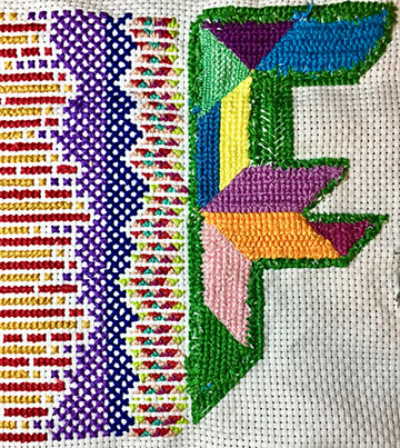 Two different cross-stitch paterns meet