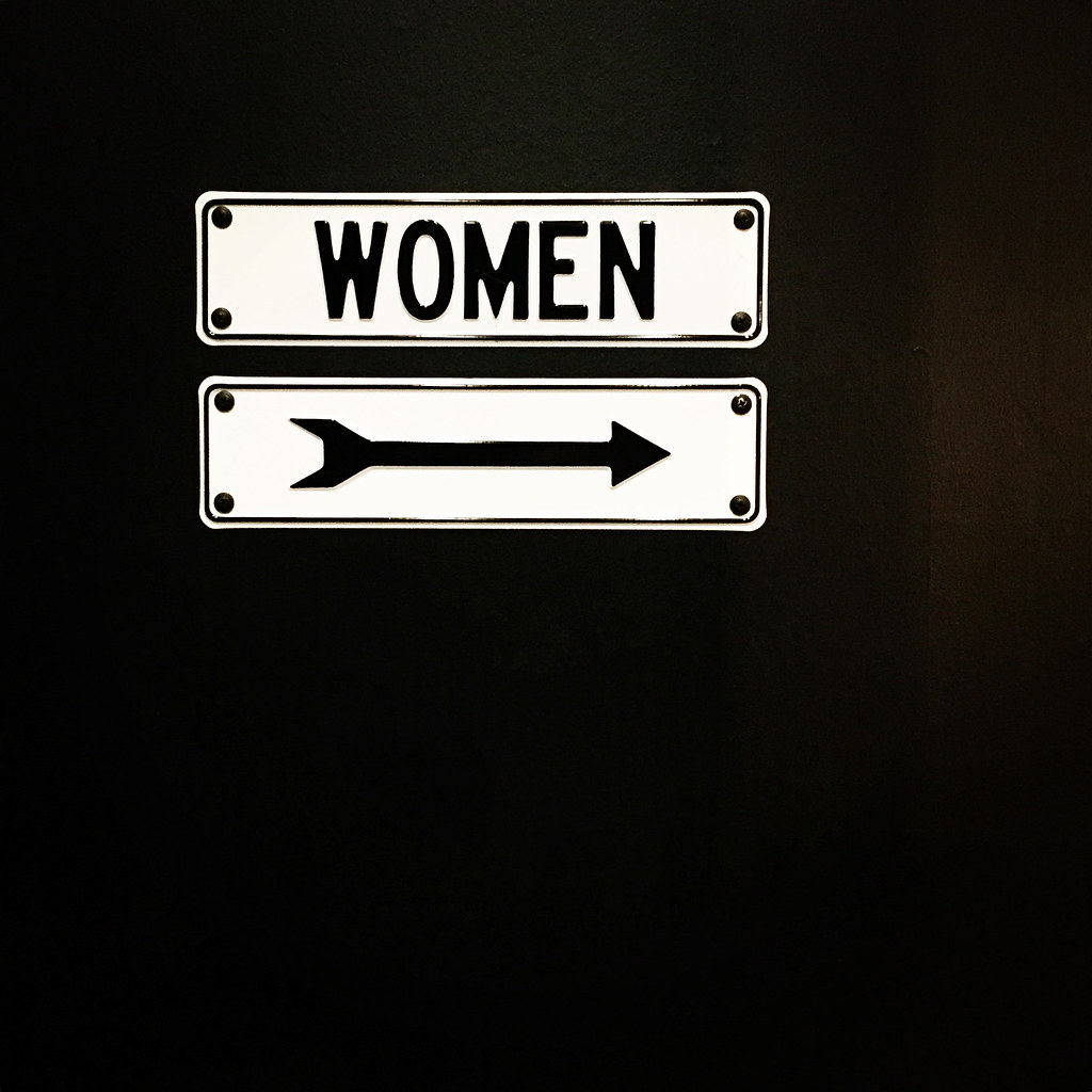 women sign with arrow pointing right