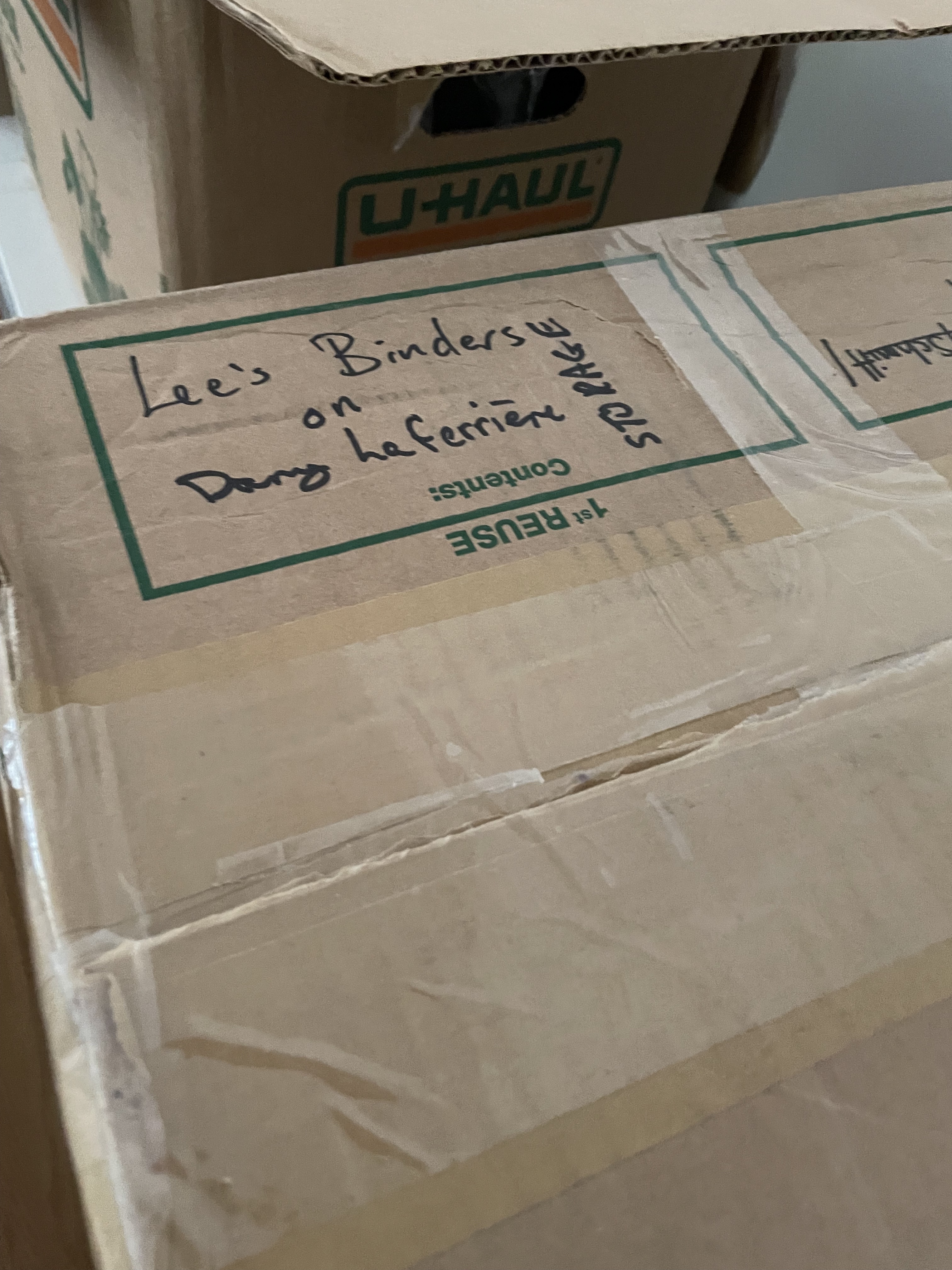 Box that says Lee's binders on Dany Laferrière