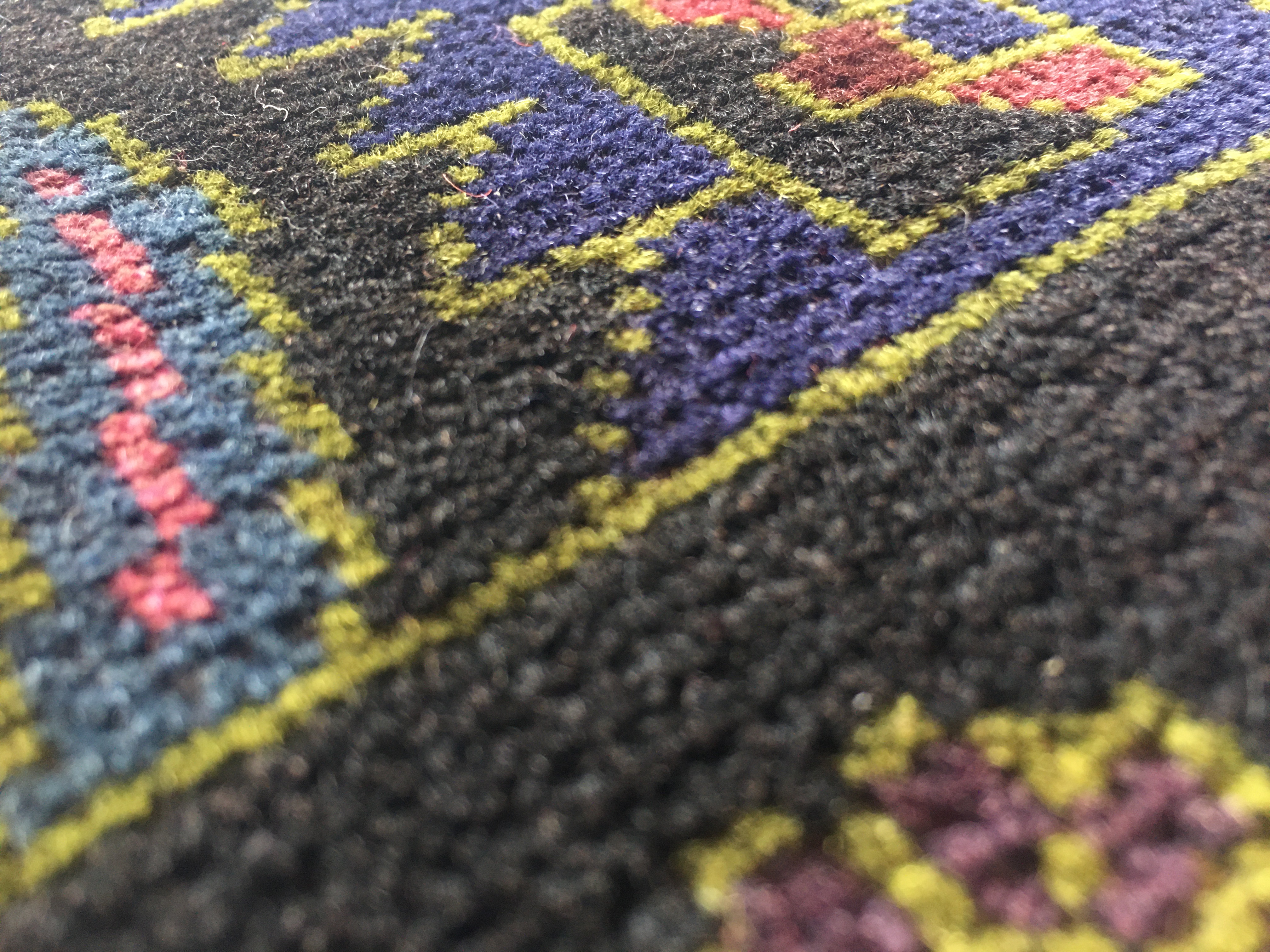 Photo looking cross the rug at different dye colors
