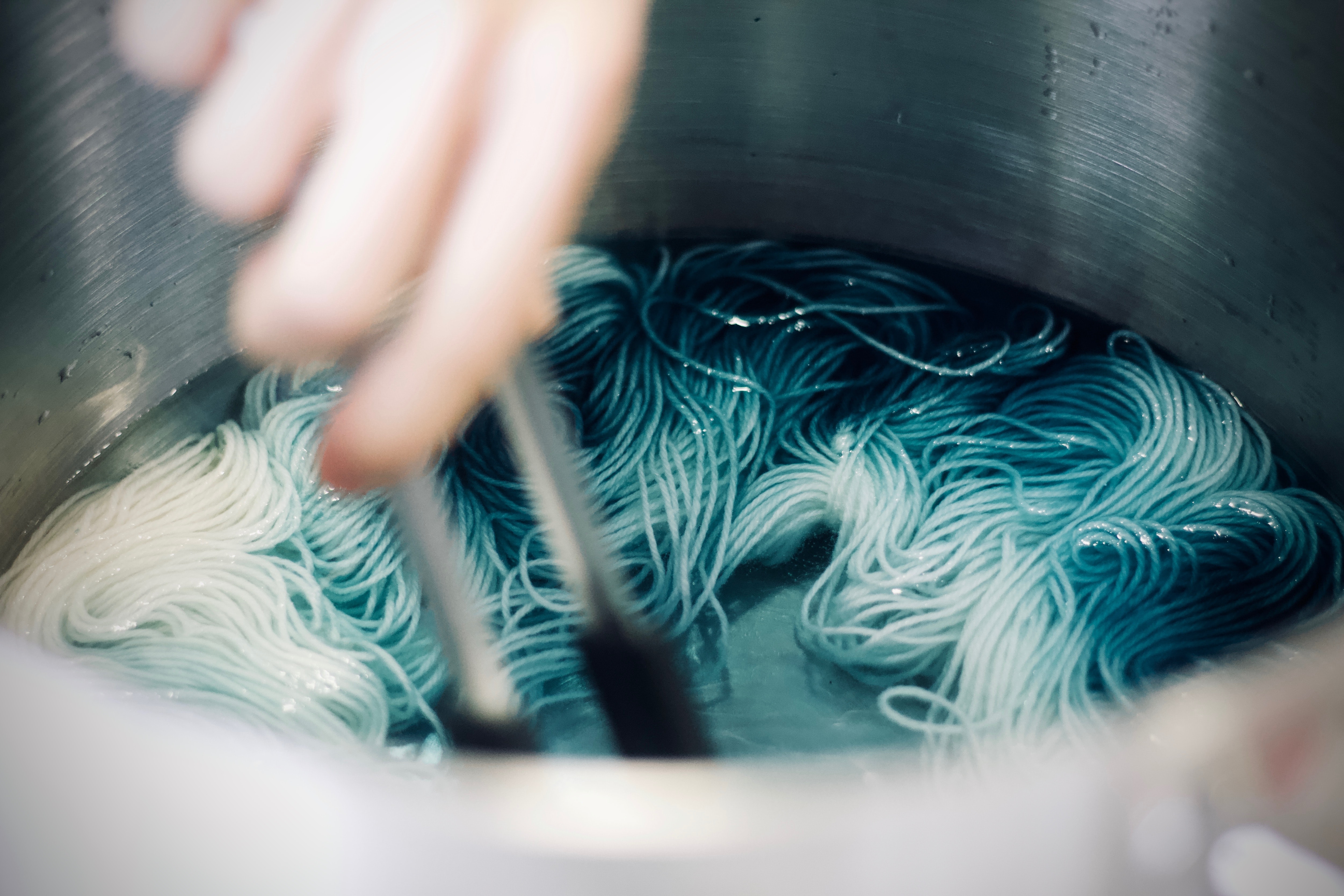 Yarn soaking in a light blue dye