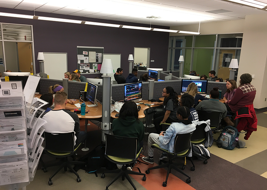 Wide shot of the UTC Library Studio, group of students at computers