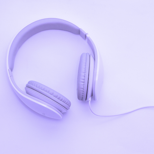 A light purple pair of over-ear headphones on a lavender backround.