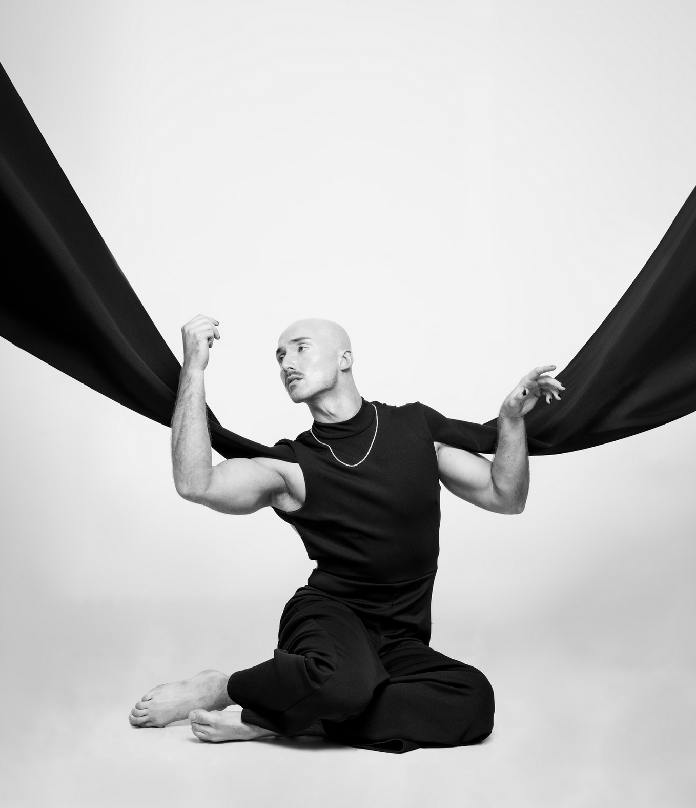 Dr. Smigles sitting in dancerly pose on the floor