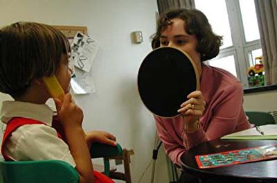 Lena listening during a session of her cochlear implant therapy.