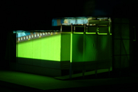 Image of green film frame cast against the side of the CompuObscura. Taken by Cal Poly Architecture class students using class-created model and slide projector, Spring 2004.