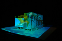Image of swimming footage cast on the full CompuObscura modeled structure.  Long short. Taken by Cal Poly Architecture class students using class-created model and slide projector, Spring 2004.