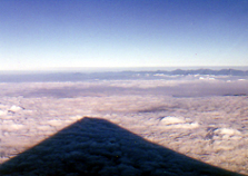 Shadow of Mt. Fuji cast on low cloud cover, taken from airplane window. Above Tokyo, Japan. Photo by David Gillette � 2005.